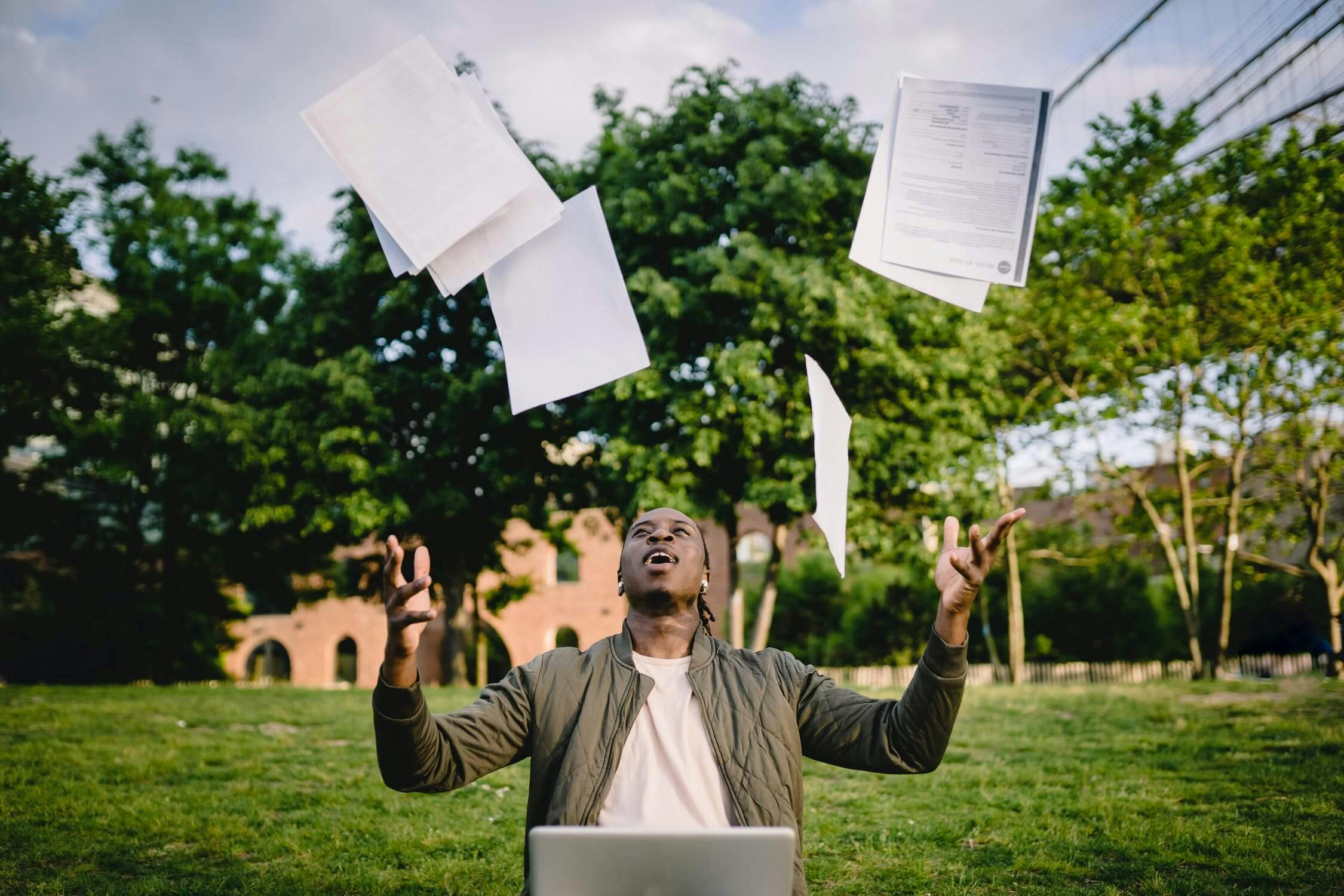 Man throwing files up to the sky